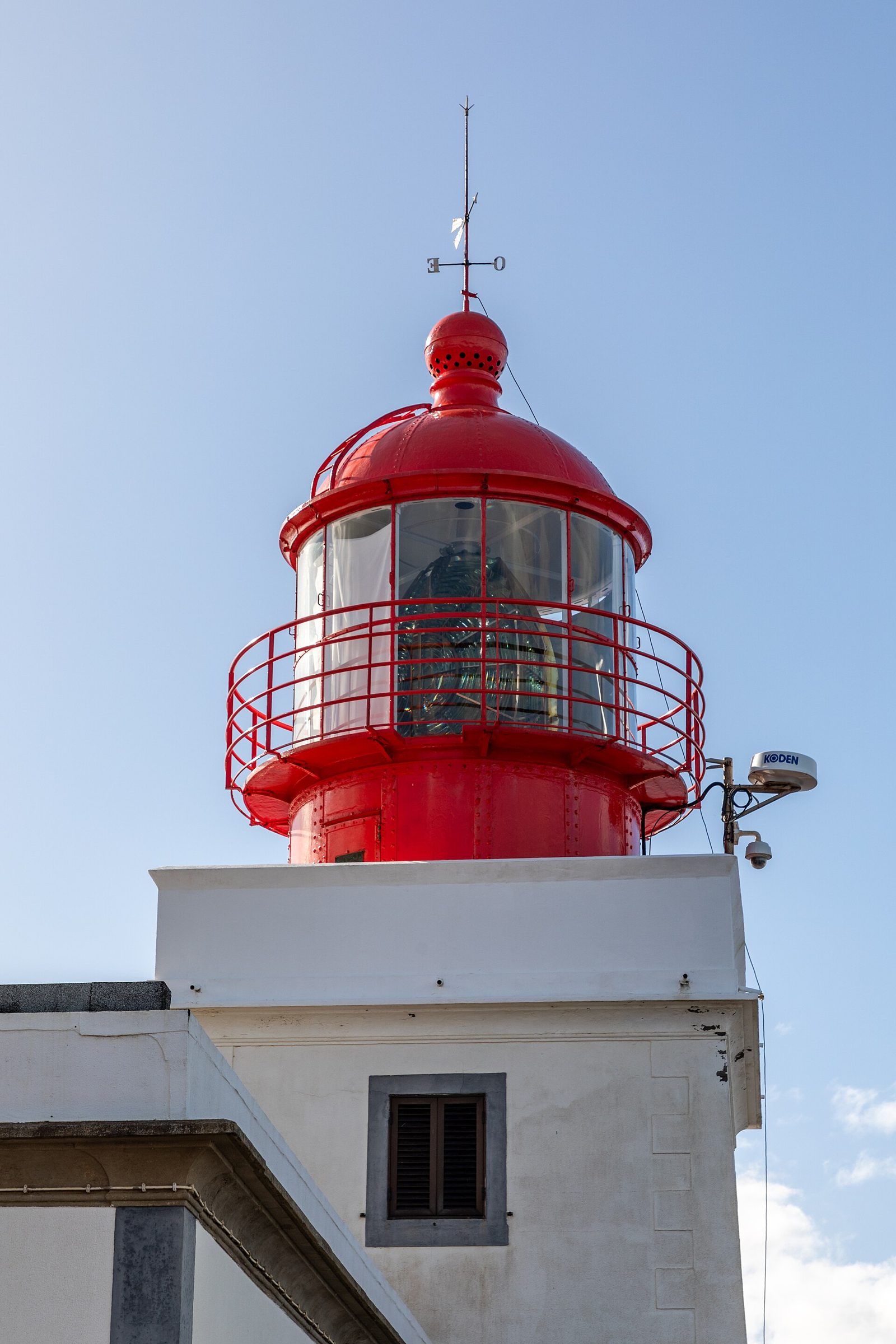 White lighthouse on a green clifftop at Ponta do Pargo