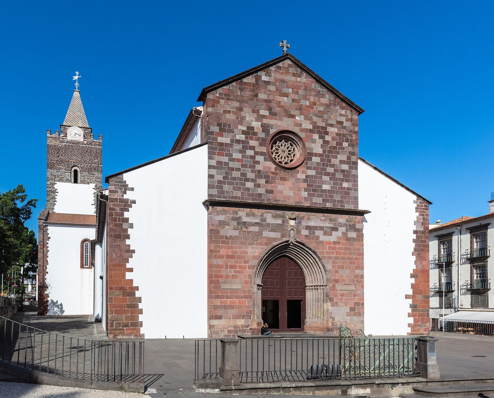 Stone facade and bell tower of Funchal's Sé Cathedral