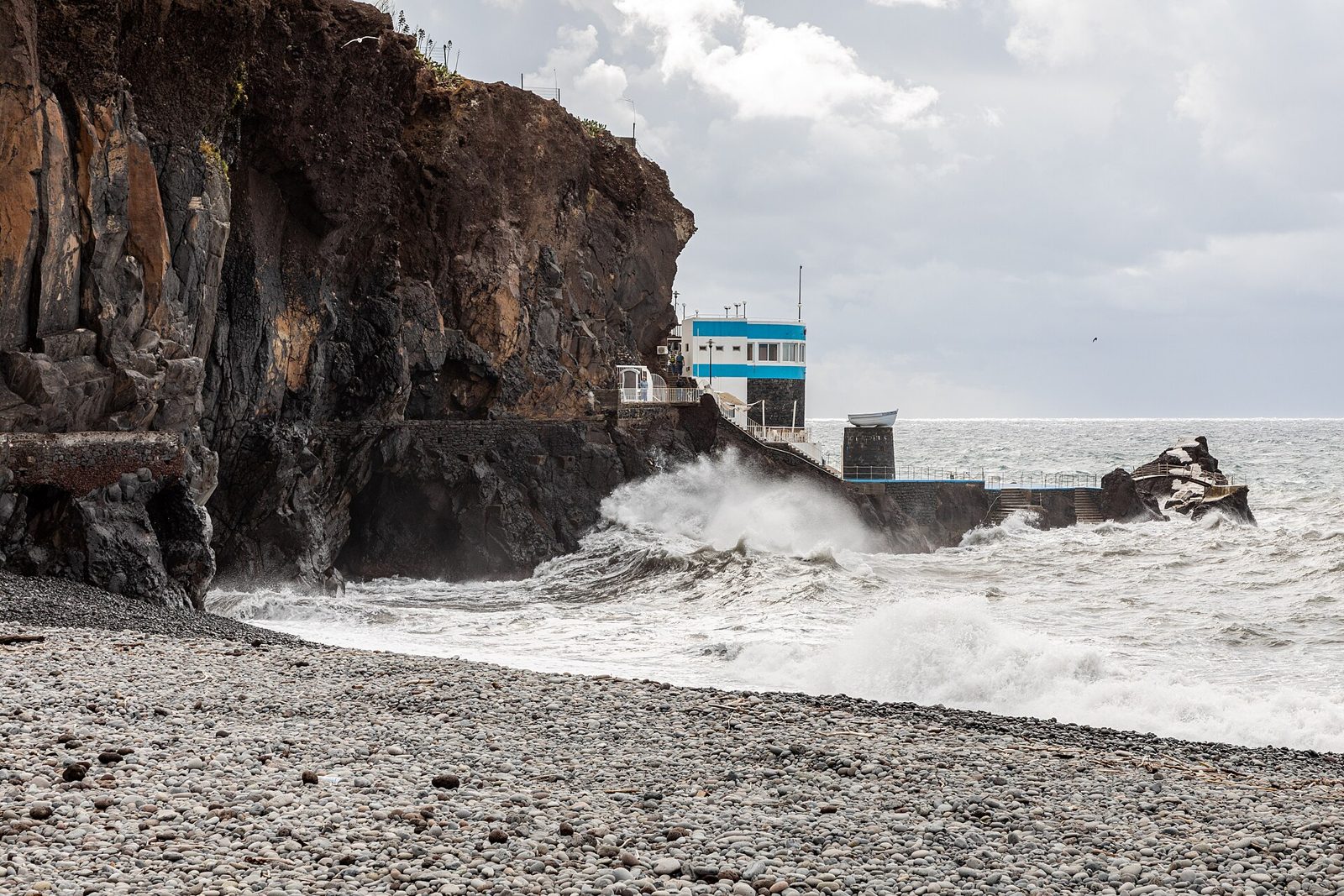 Pebble and dark sand coves along the Praia Formosa shoreline in Funchal