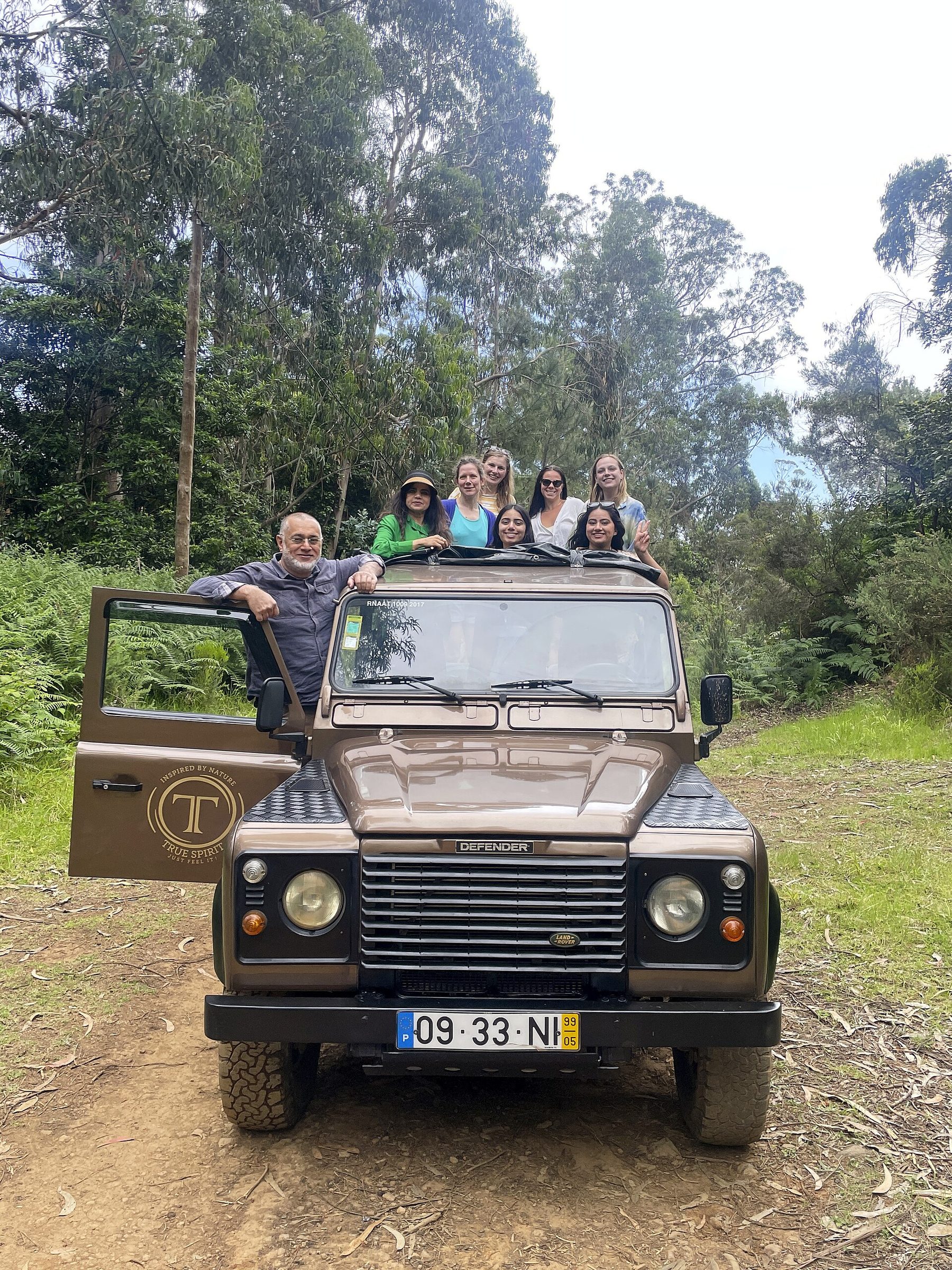 Open 4x4 jeep on a mountain track above green Madeiran valleys