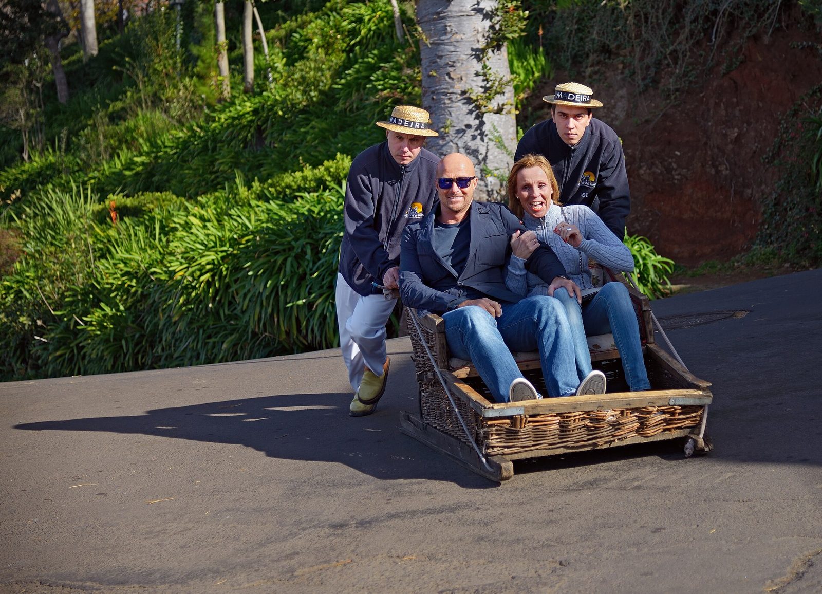 Wicker toboggan being steered downhill by two carreiros in Monte